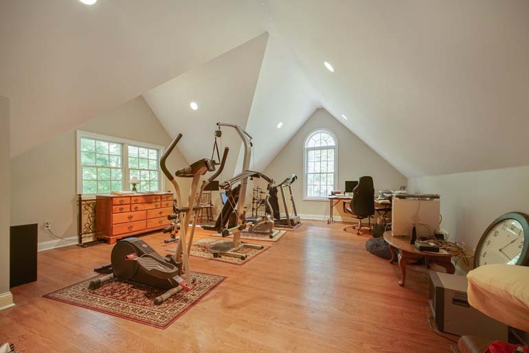 Before image of a cluttered gym/home office space