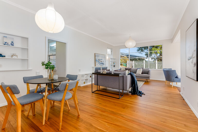 Before and after real estate photo editing of a brightened living room and dining area.