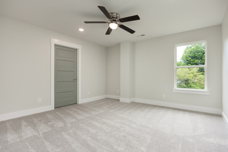 Real estate listing photo showing an empty room digitally furnished using AI virtual staging