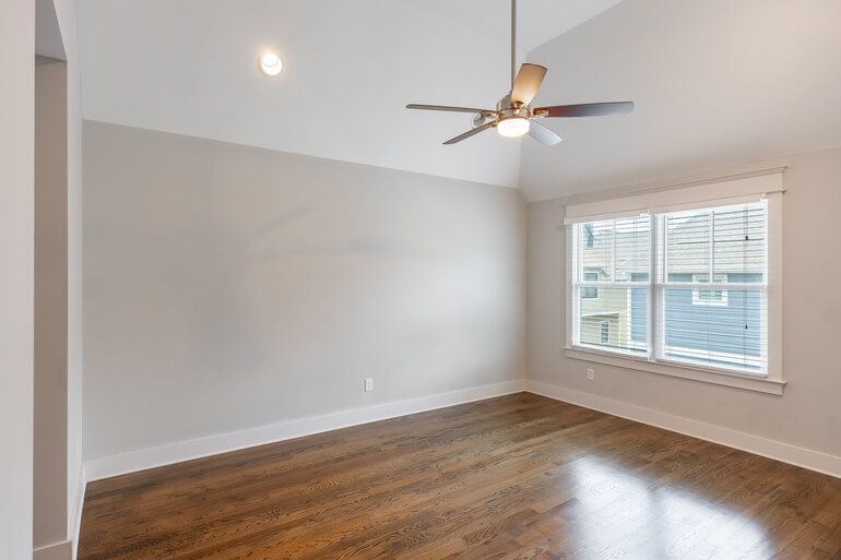 Before and after comparison of an empty room and AI virtual staging