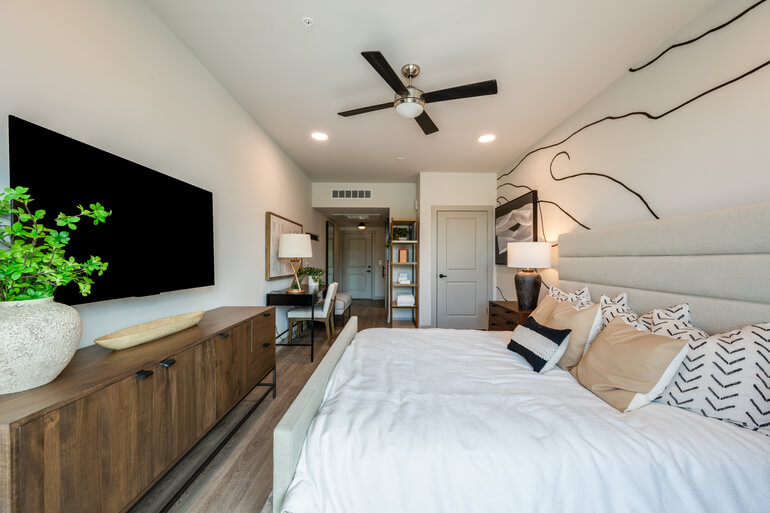 Interior photography comparison showing bracketed exposures versus a final blended image in a modern bedroom.