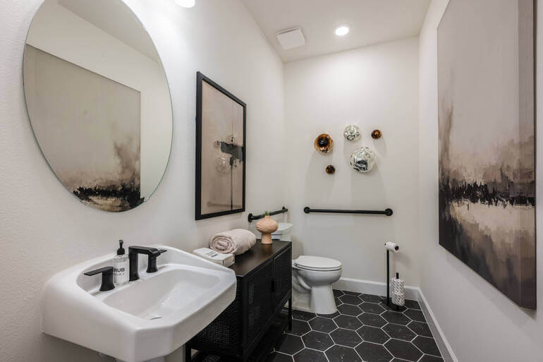 PhotoUp HDR photo editing comparison showing bracketed exposures versus a final edited bathroom interior.