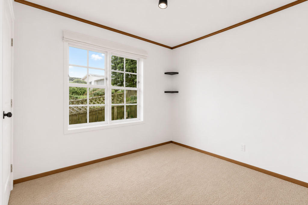 Empty dining room with white walls and a large window.
