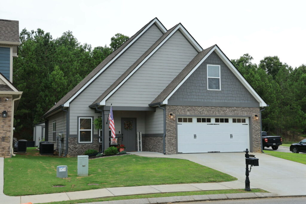 Home exterior with a vehicle visible near the driveway.