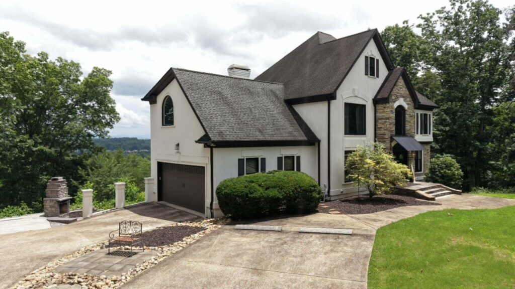 Luxury home exterior before color grading under cloudy skies.