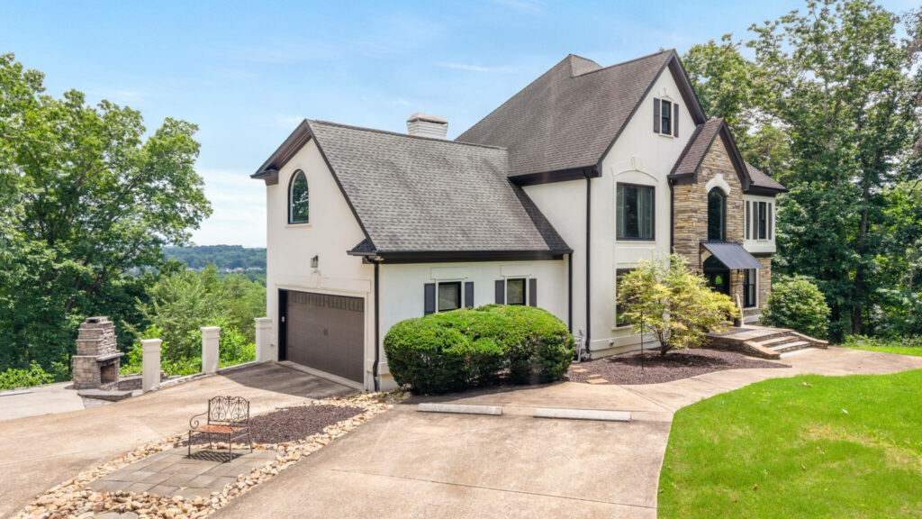 Luxury home exterior with enhanced colors, contrast, and blue sky.