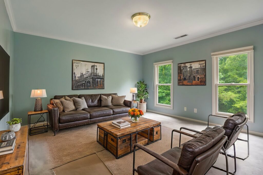 Industrial-style living room virtually staged with leather seating and wood accents.