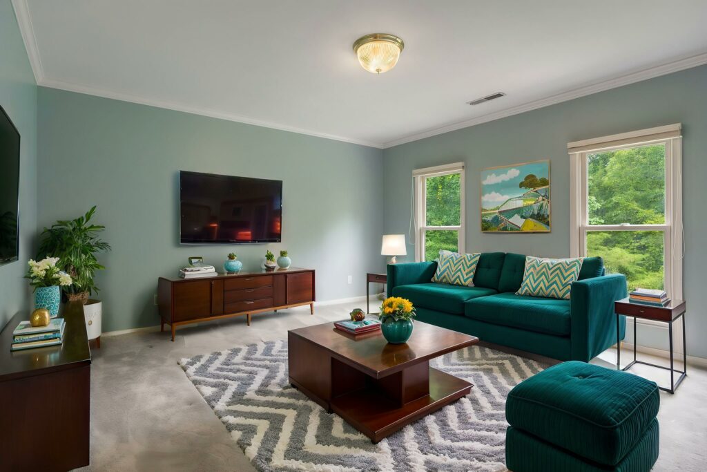 Mid-century modern living room virtually staged with teal furniture and wood accents.