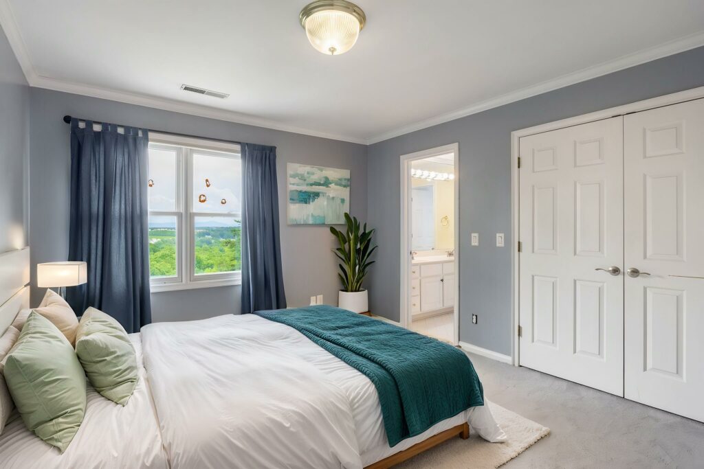 Modern bedroom virtually staged with a platform bed, teal accents, and minimalist décor.