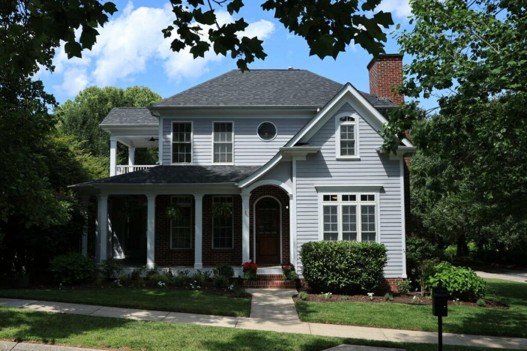 Unedited exterior photo of a two-story home before photo editing outsourcing.