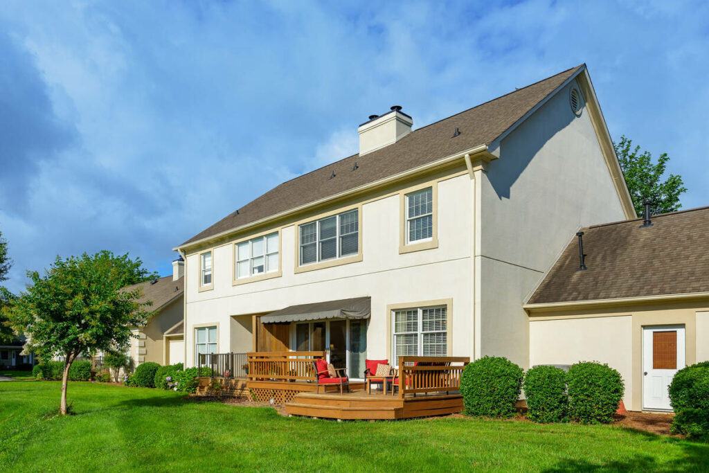 Professionally edited backyard exterior of a two-story home after photo editing outsourcing.
