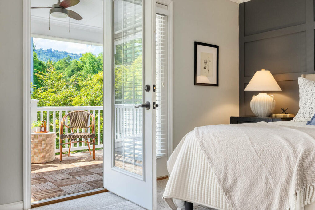 Bright bedroom with balcony enhanced using HDR photography.