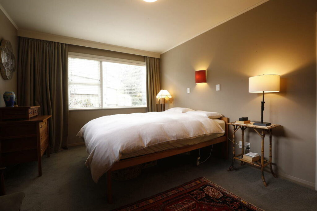 Bedroom photographed in low interior lighting.