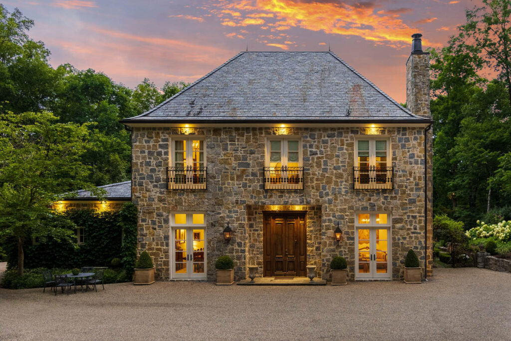 Luxury home enhanced with dramatic twilight sky.