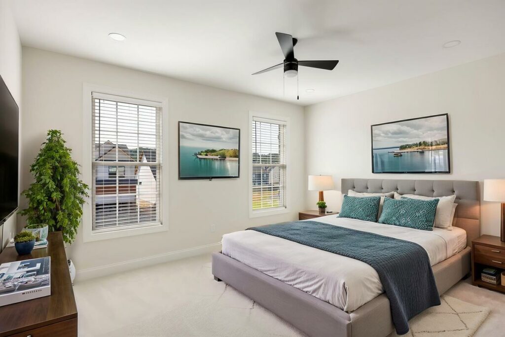 Modern bedroom featuring neutral furniture and blue accents.