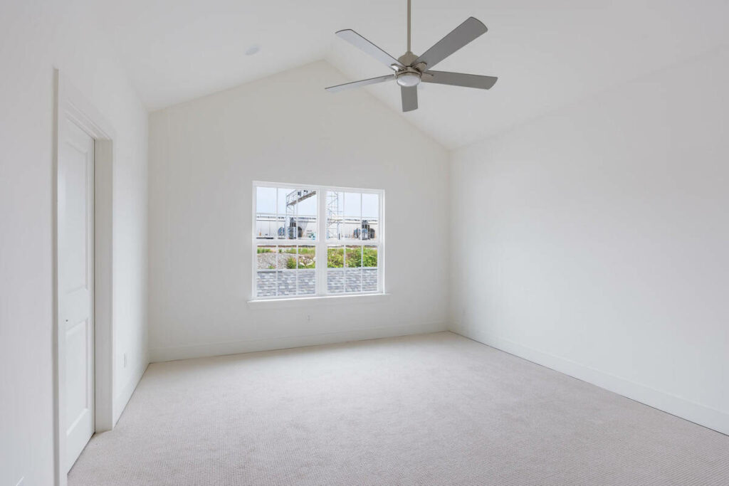 Empty vaulted bedroom before AI virtual staging
