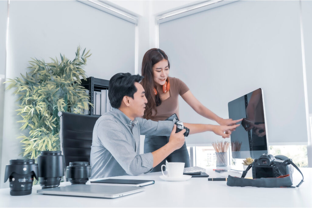 Photographer training with a team member as part of a virtual assistant vs employee workflow for real estate photography.