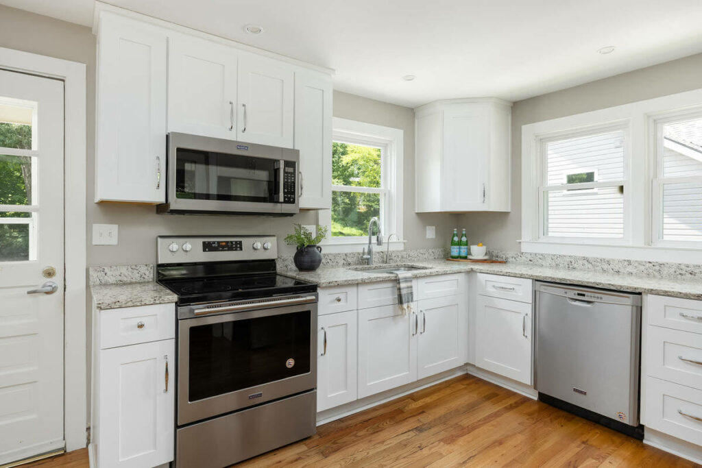 AI real estate photo editing creating a bright, naturally lit modern kitchen for a property listing.