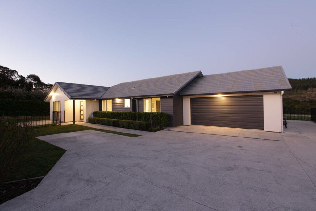 AI real estate photo editing showing a modern home exterior before a twilight conversion.