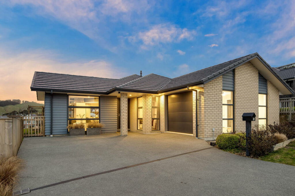 AI real estate photo editing transforming a home exterior with a vibrant twilight sky replacement.