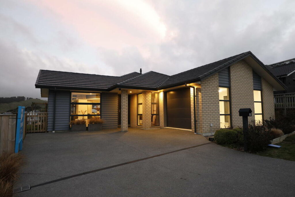 AI real estate photo editing example of a home exterior before twilight sky enhancement.