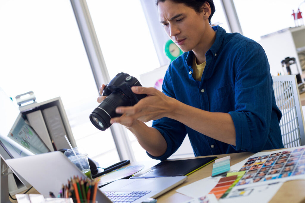 Real estate photographer reviewing camera during a busy virtual assistant real estate photography workflow