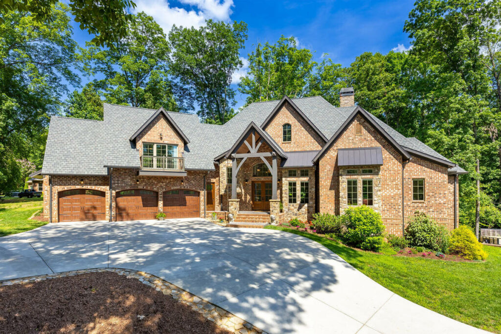 AI image enhancement of a luxury brick home with a three-car garage