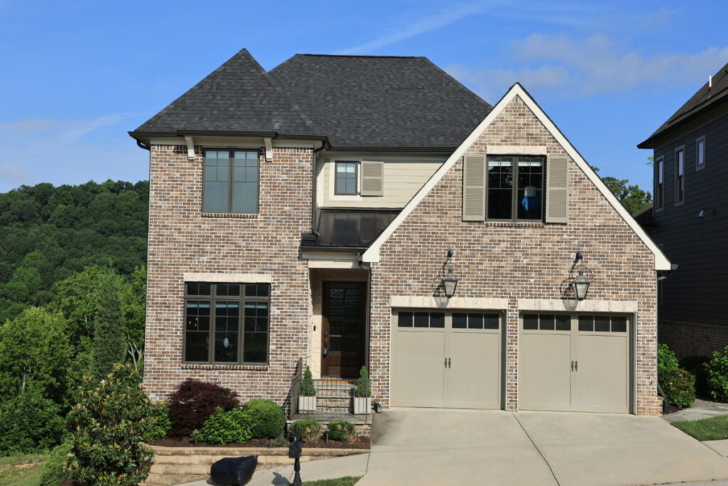 Two-story brick home before AI image enhancement