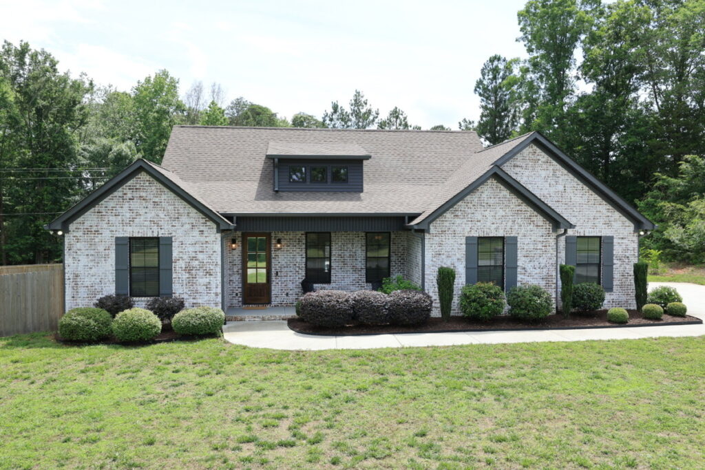White brick home exterior before AI image enhancement