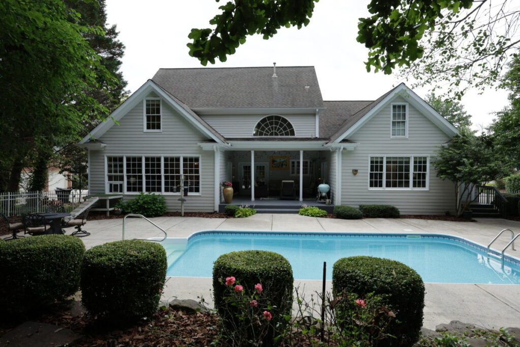 Backyard and pool photo before AI image enhancement