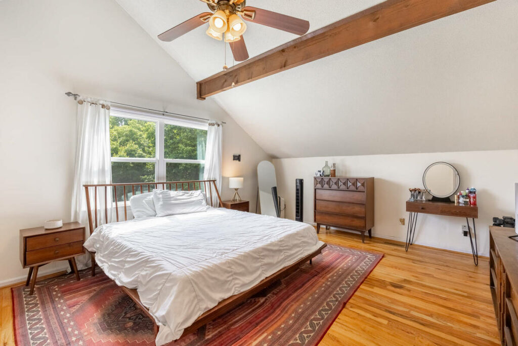 HDR real estate photo editing services for a bright bedroom with vaulted ceiling