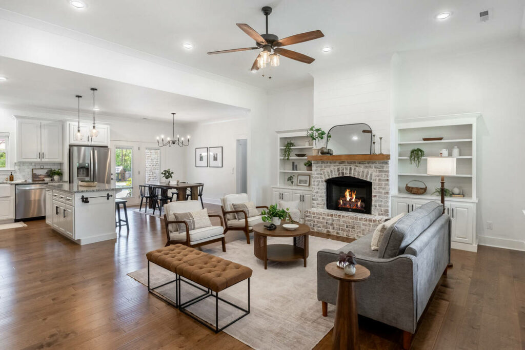 HDR real estate photo editing services for a bright open-plan living room with fireplace