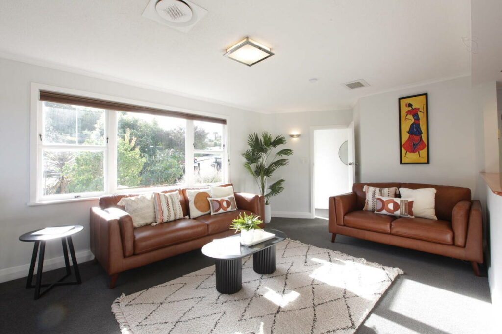 Living room before AI real estate photo editing with bright window exposure