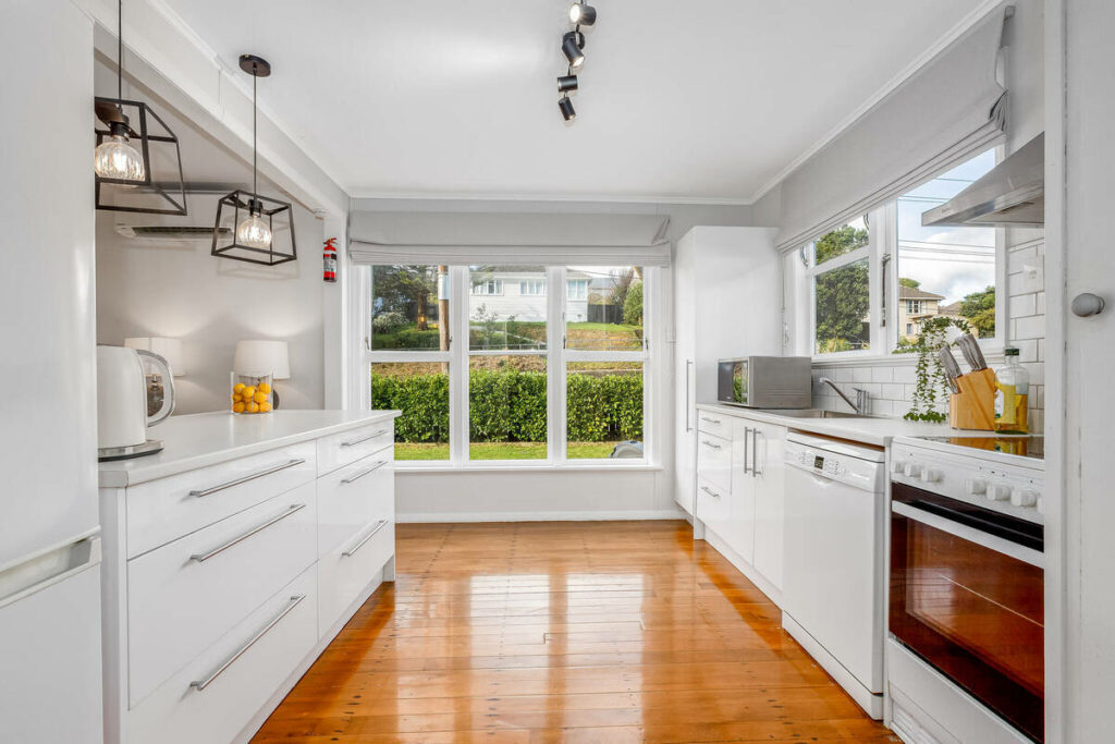 AI real estate photo editing of a bright white kitchen