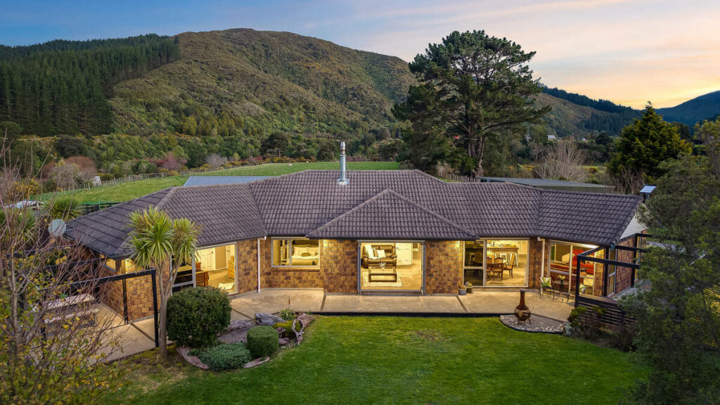 Aerial home exterior after AI real estate photo editing at dusk