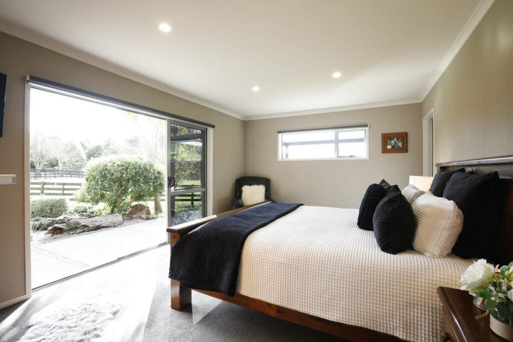 Bedroom before AI real estate photo editing with overexposed windows