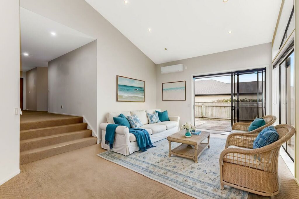 AI virtual staging of a living room with white sofa and wicker chairs