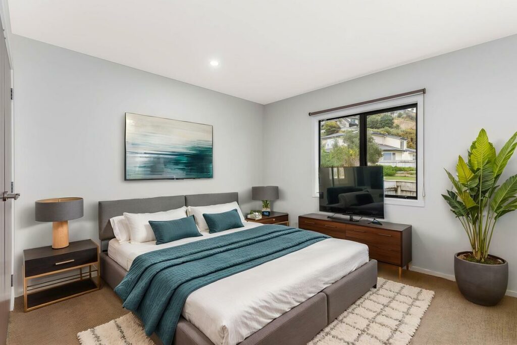 AI virtual staging of a modern bedroom with teal accents