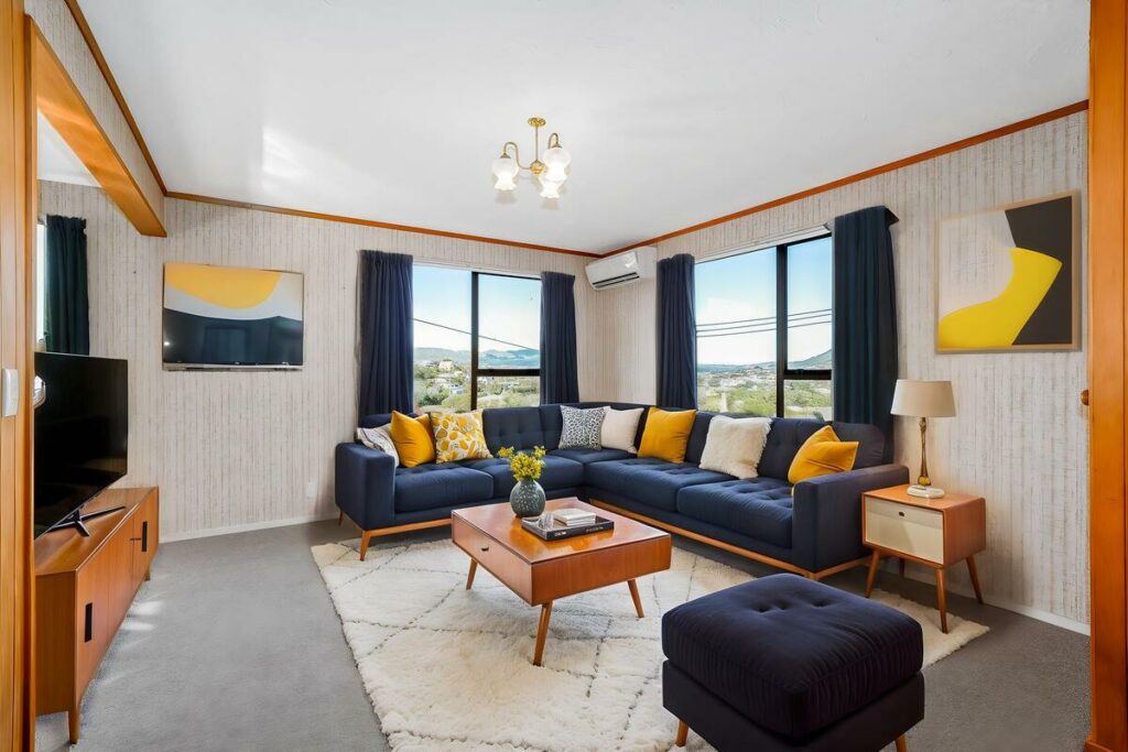 AI virtual staging of a living room with navy seating and yellow accents