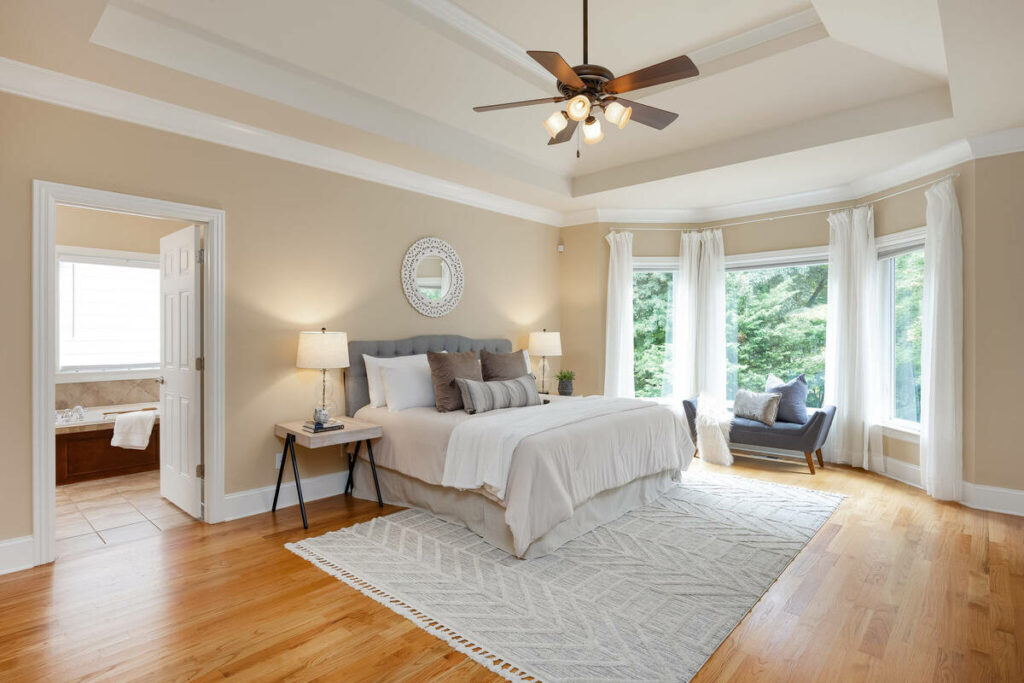 Professional photo editing of a bedroom with corrected lighting and color