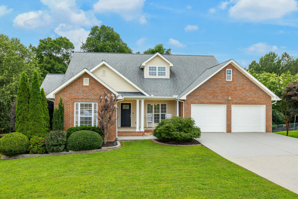 Professional photo editing with blue sky replacement on a house exterior