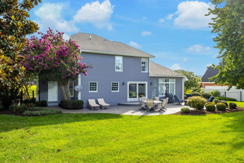 Professional photo editing with blue sky replacement on a backyard exterior