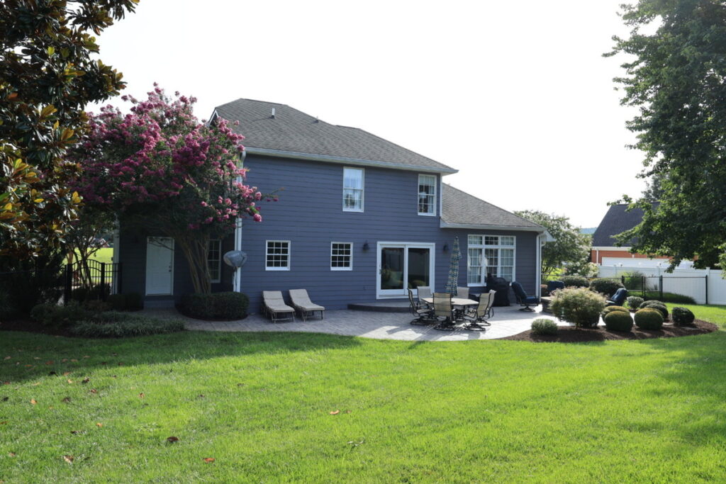 Backyard exterior with overexposed sky before professional photo editing