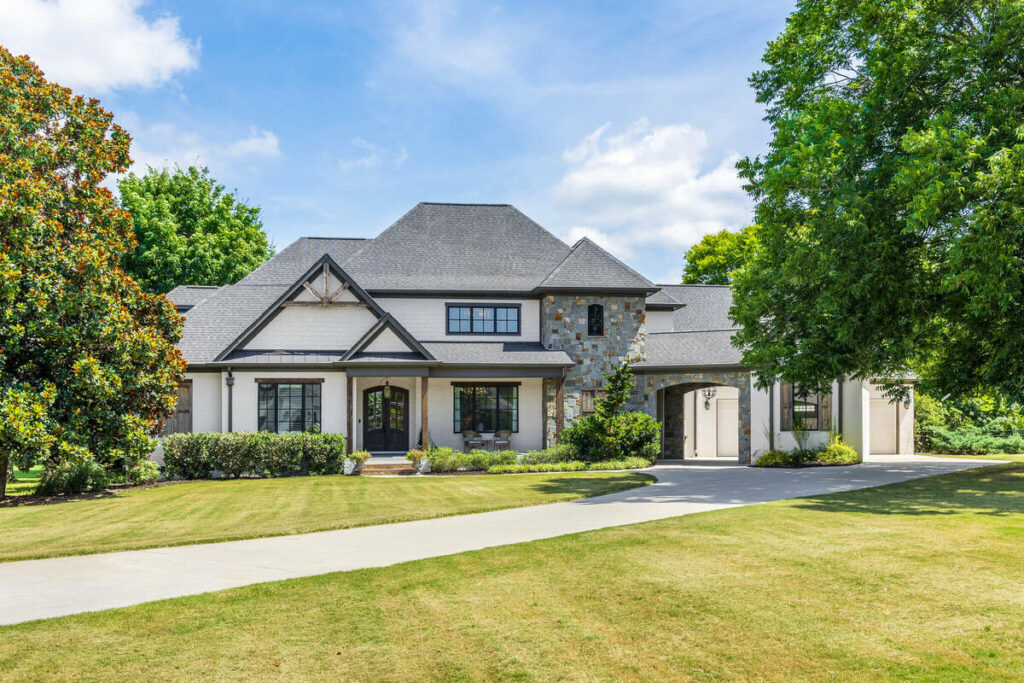 Professional photo editing of a luxury home exterior in daylight