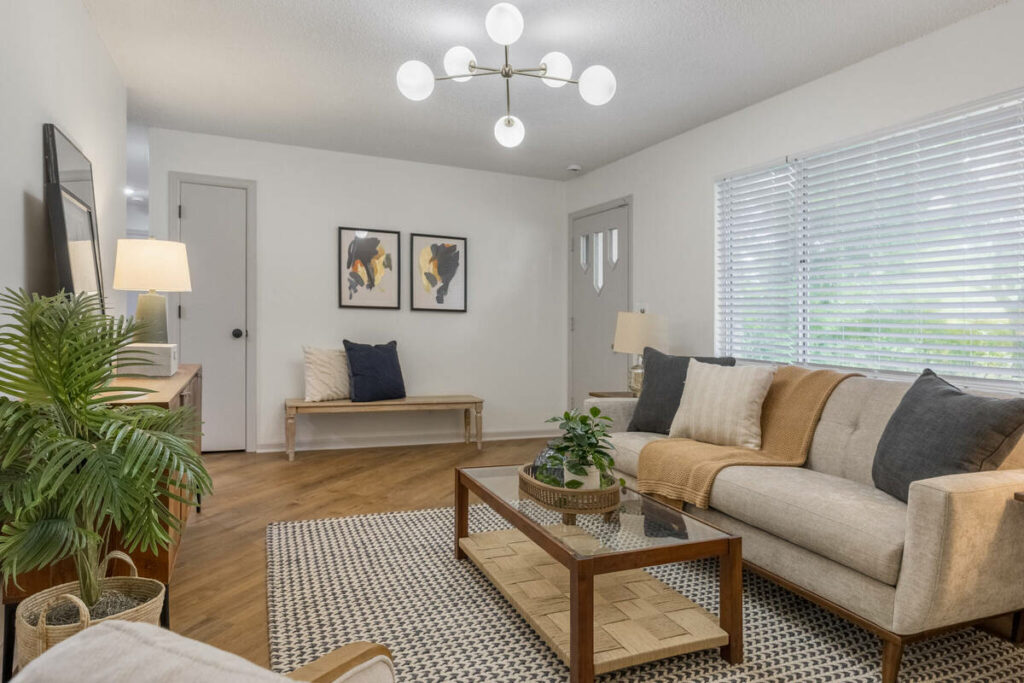 Professional photo editing of a bright staged living room