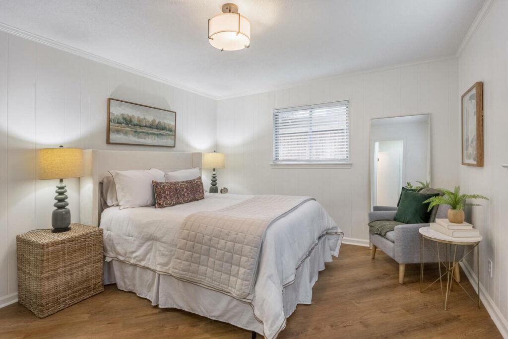 Professional photo editing of a bright staged bedroom