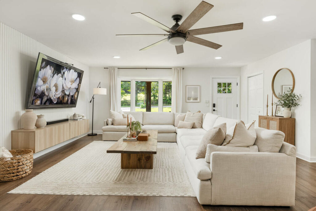 Real estate photo editing services enhancing a living room with brighter, balanced lighting.