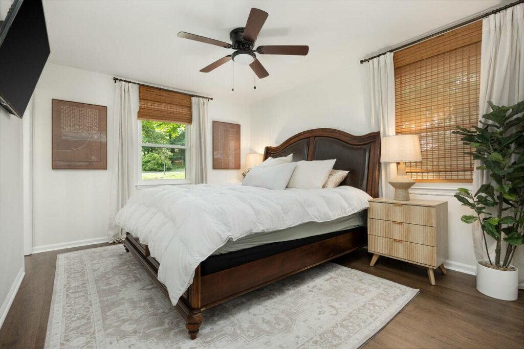 Bright bedroom enhanced with real estate photo editing services.
