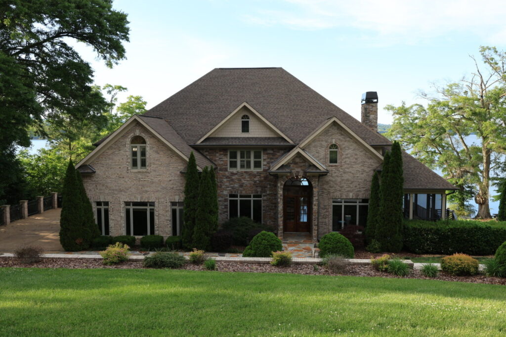 Home exterior before sky replacement and real estate photo editing services.