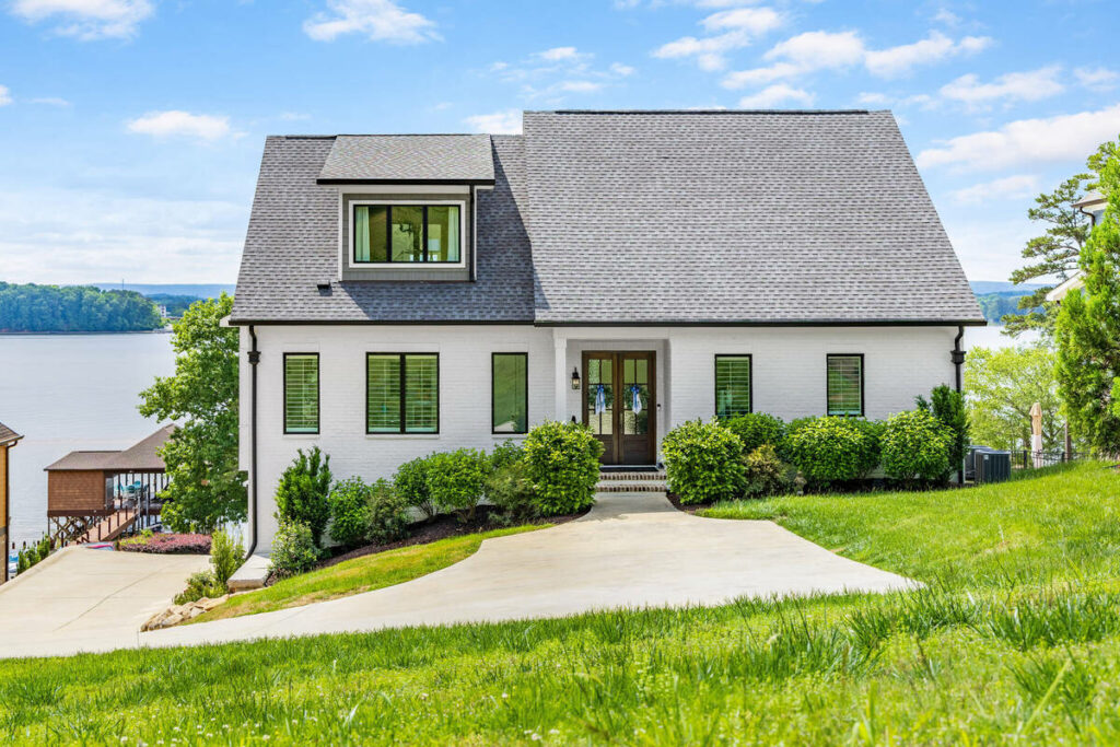 Lakefront home exterior enhanced with real estate photo editing services.